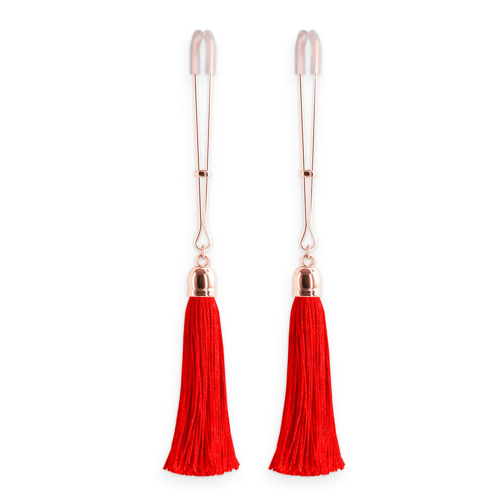 Crimson tassels dangle from cheeky nipple clamps. A delightful tug of tantalisation.
