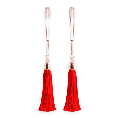 Crimson tassels dangle from cheeky nipple clamps. A delightful tug of tantalisation.
