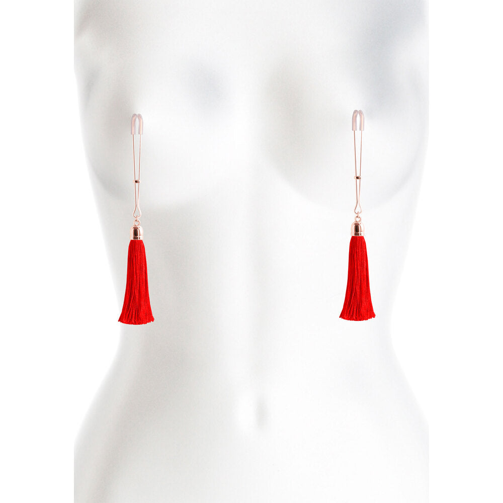 Nipple clamps with flirtatious scarlet tassels; daring treasures adding a playful allure.