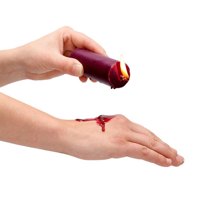 Wax play candle being dripped onto skin.