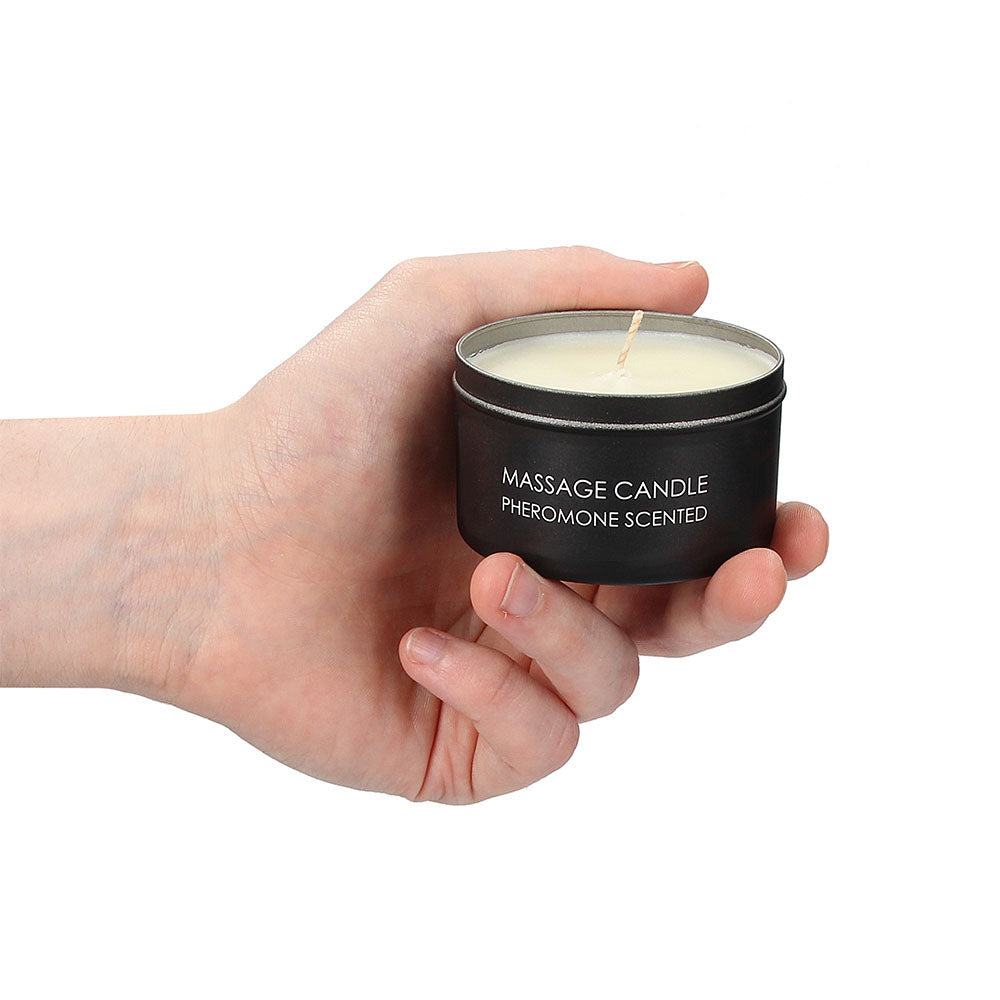 Massage candle, pheromone scented in hand.