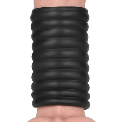 Black ribbed vibrating penis sleeve on a penis.