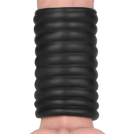 Black ribbed vibrating penis sleeve on a penis.