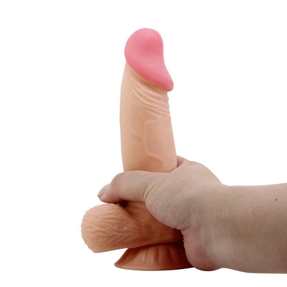 Duvall dildo held in hand for size.