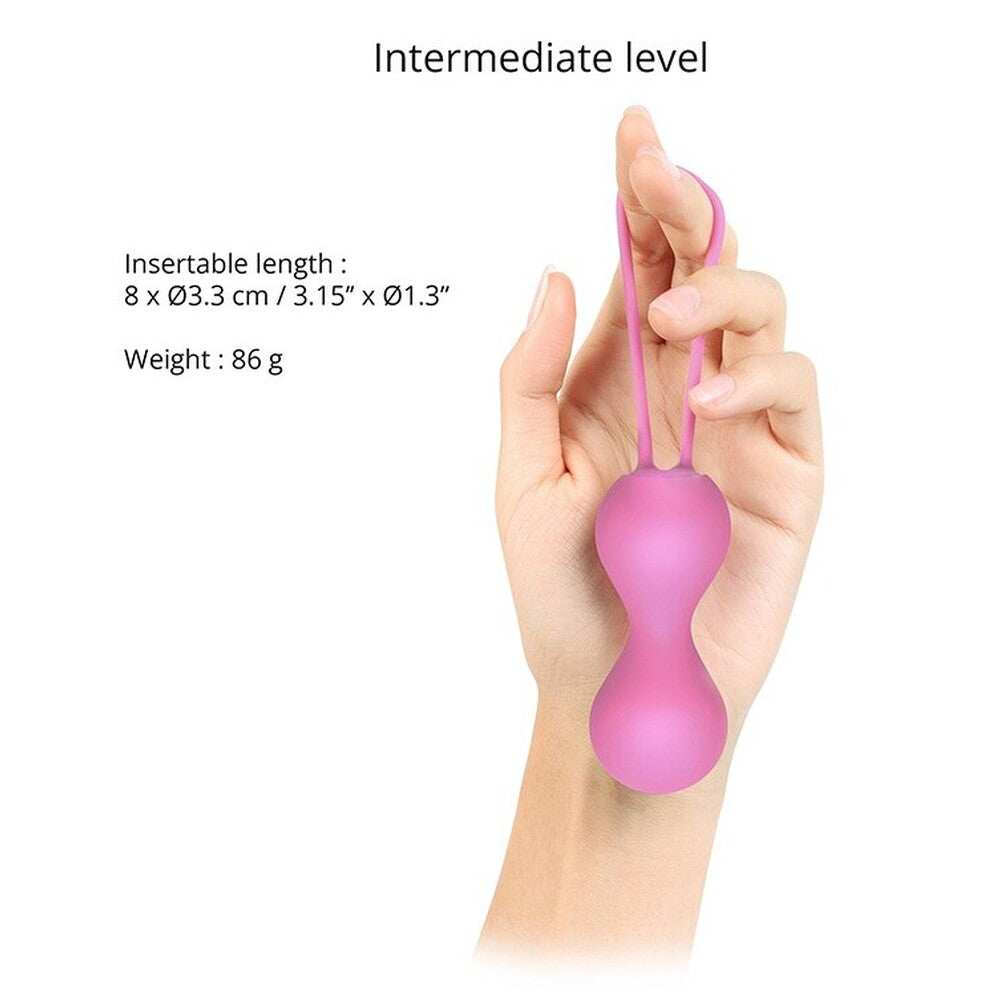 Pink Love To Love Joia Kegal Balls, intermediate level, for pelvic floor exercise, held in hand.