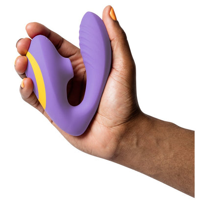 Hand holding a purple pleasure toy