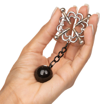 Nipple grips with weights held in a hand.