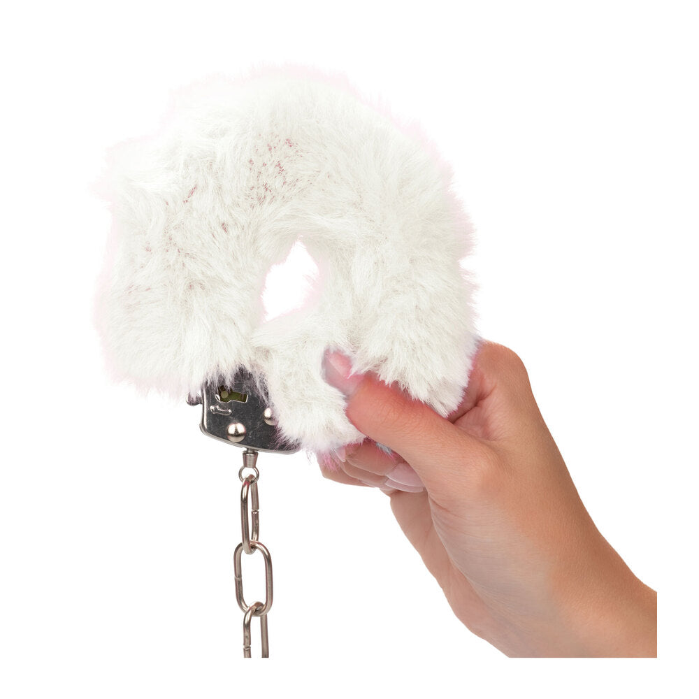 White furry cuffs in hand.