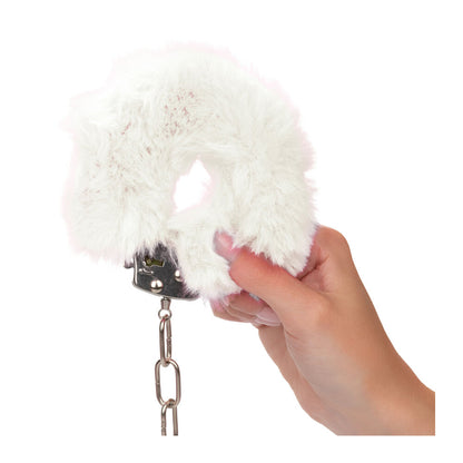 White furry cuffs in hand.