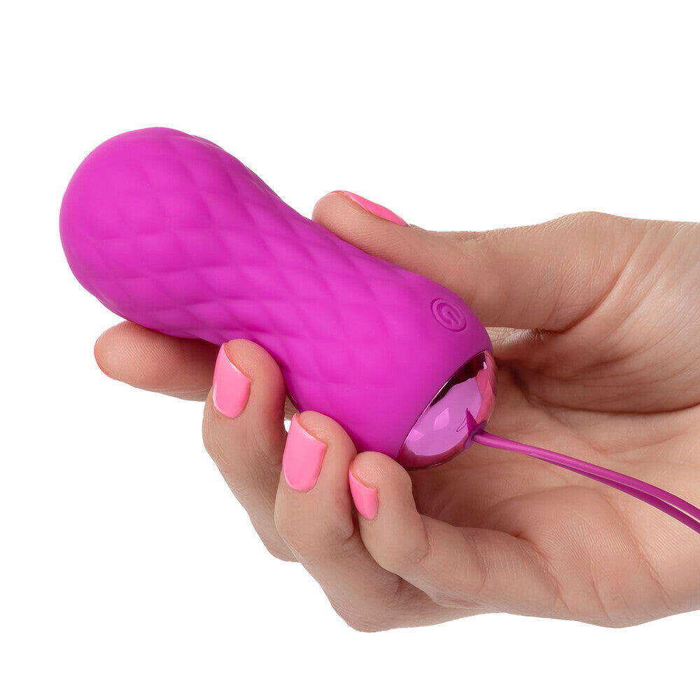 Pink Slay SPIN Remote Control Textured Bullet vibrator in a hand
