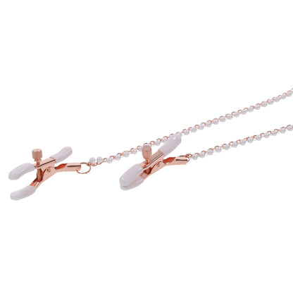 Rose gold nipple clamps with pearl chain.
