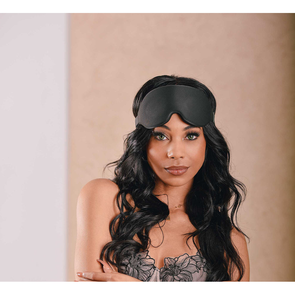 Sensual woman wearing a Sportsheets Blackout Blindfold.
