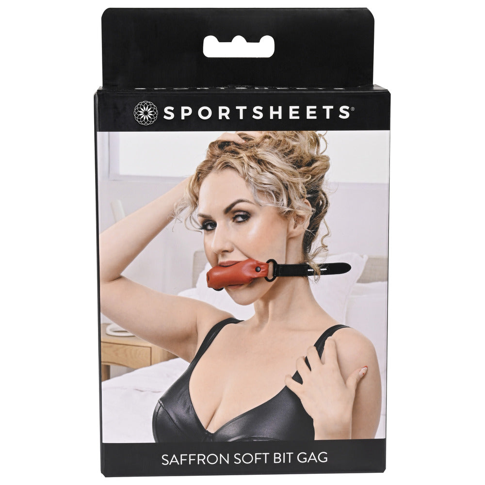 Sportsheets Saffron Soft Bit Gag box, featuring a woman with the gag, bedroom scene.