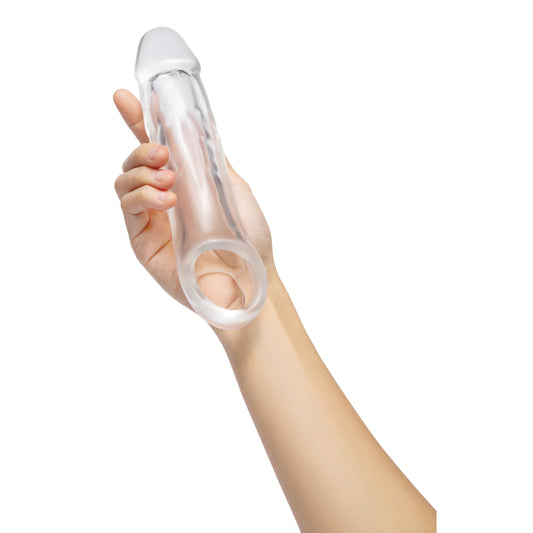 Clear penis extender held in hand